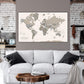 a living room with a white couch and a map on the wall