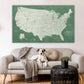 a dog sitting on a couch in front of a map of the united states