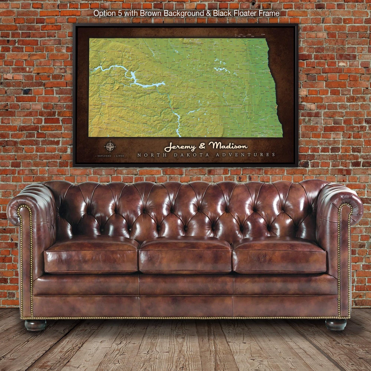 a brown leather couch sitting in front of a brick wall