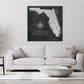 a living room with a white couch and a black and white map