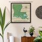 a framed map of the state of minnesota hangs on a wall