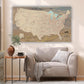 a living room with a couch and a map on the wall