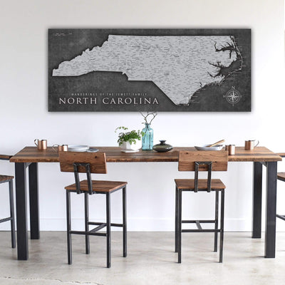 a dining room table with chairs and a map on the wall