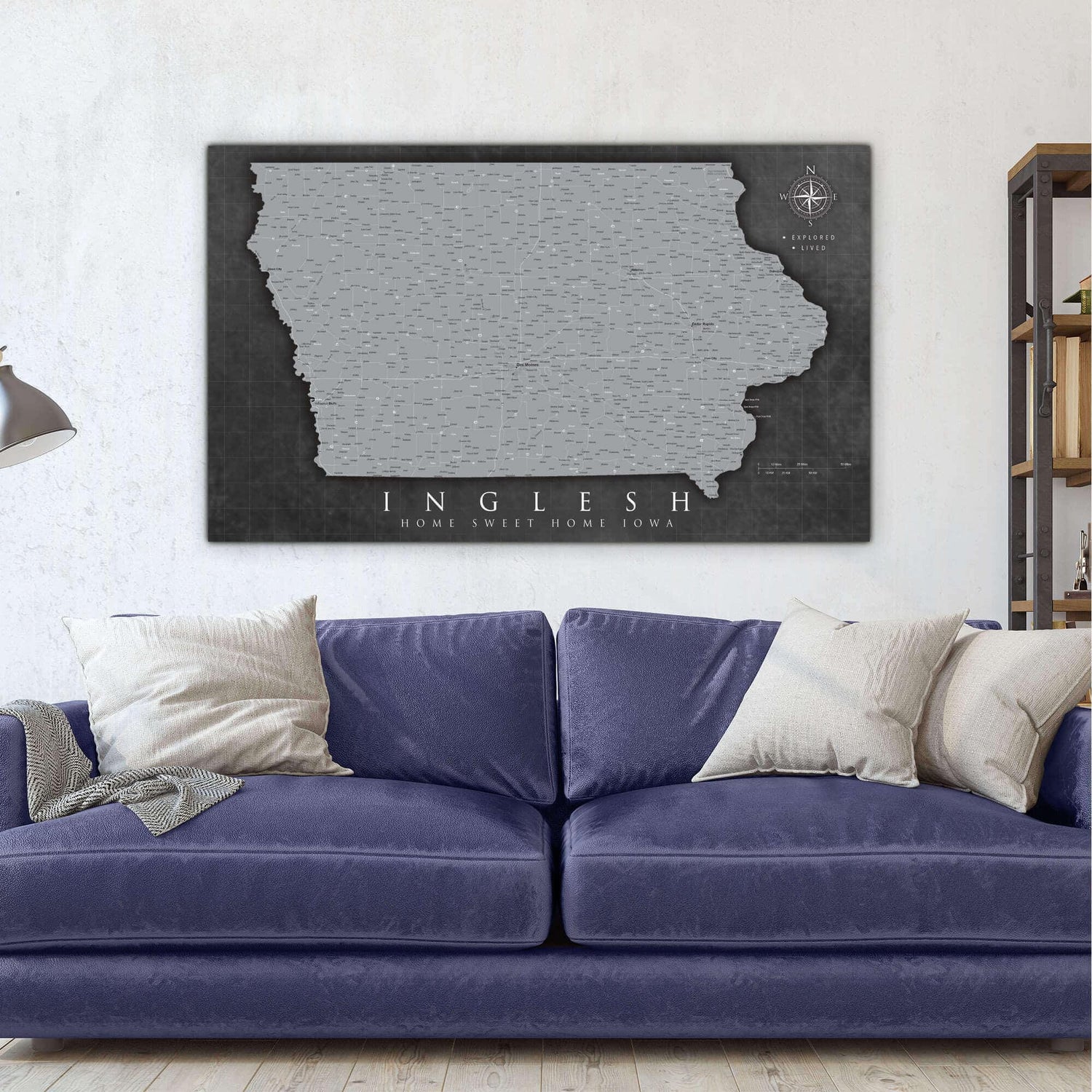 a living room with a blue couch and a map of the state of indiana